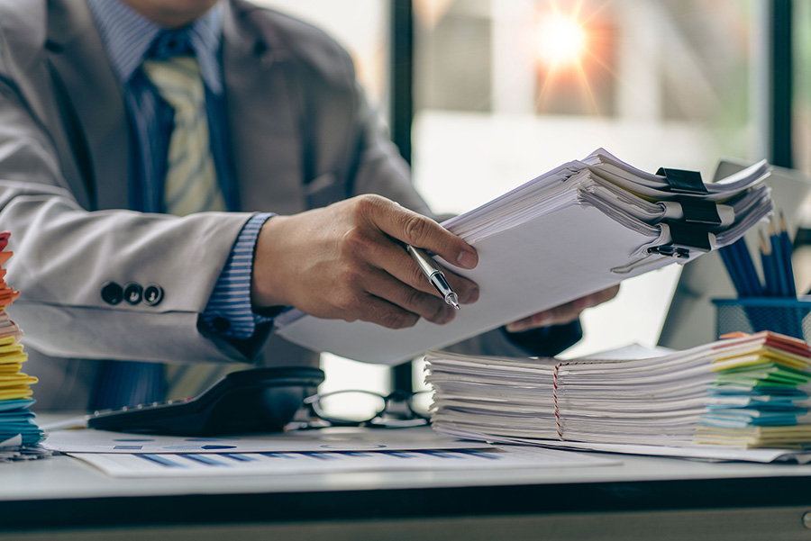stack of paperwork on desk