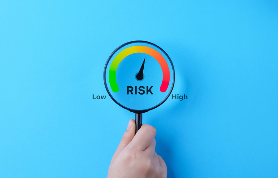 Magnified glass over a high risk indicator arrow graphic