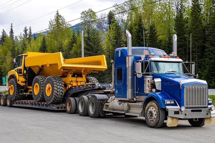 Semi truck towing a construction vehicle
