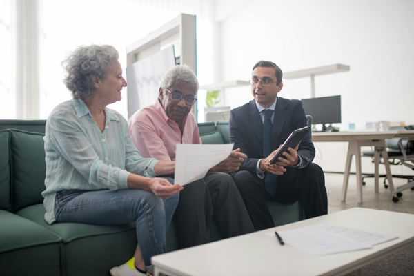 advisor with older woman on couch
