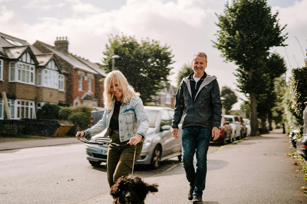 couple walking dog