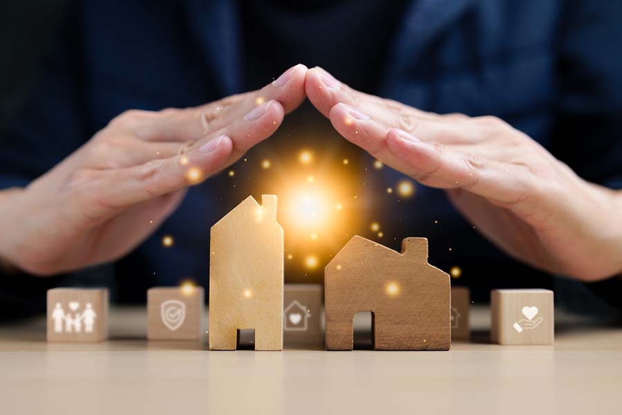 hands over a group of model houses