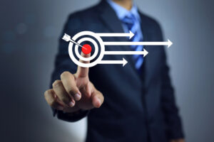 man with suit finger with a finger on the bullseye of a target
