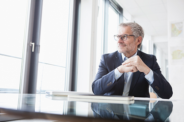 successful businessman sitting at desk in his