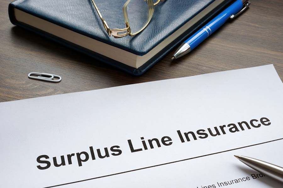surplus line insurance paperwork on a desk