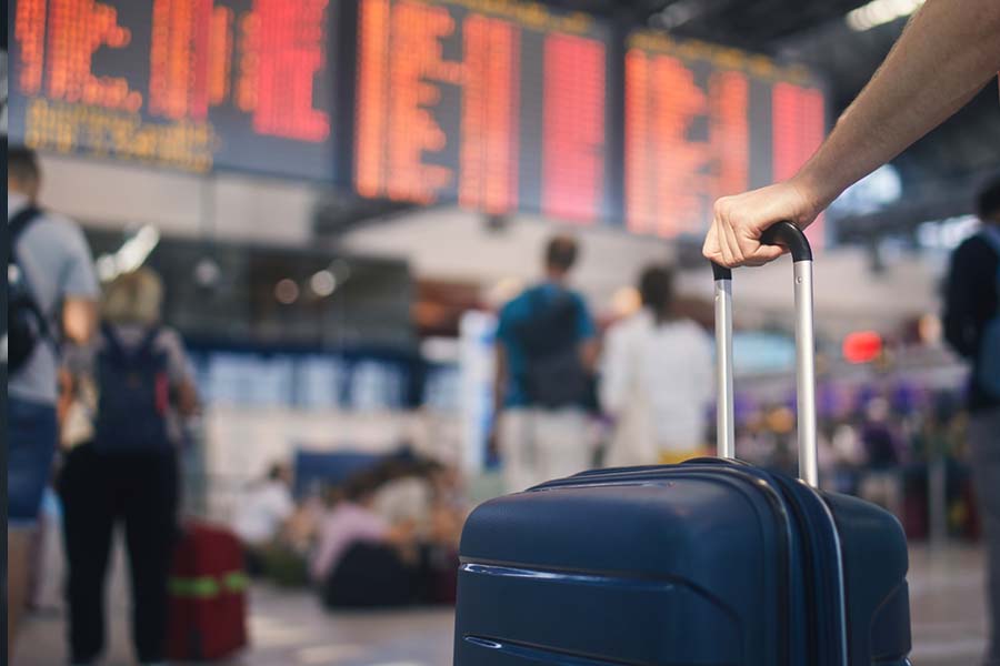traveling in airport with suitcase