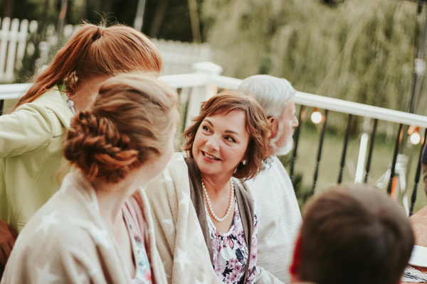 woman with family sitting outside on porch